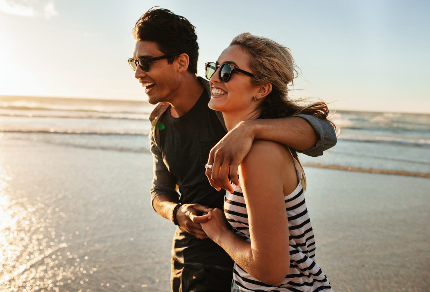 Couple walking along a beach.