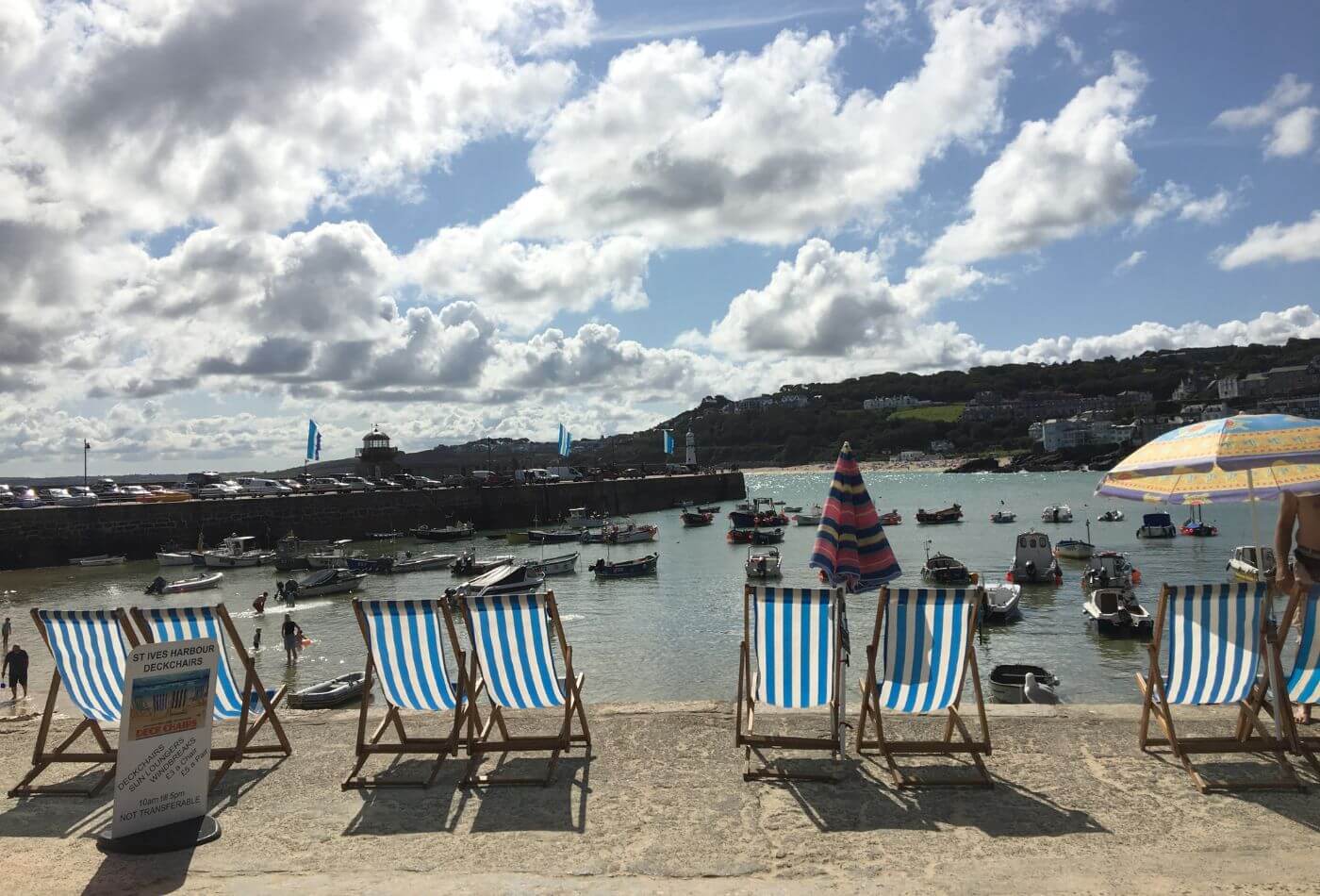 Deck chairs in front of St Ives harbour.