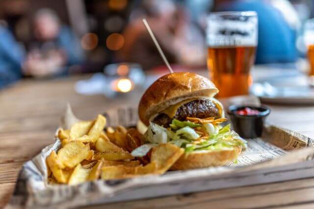 Burger and chips on a tray.