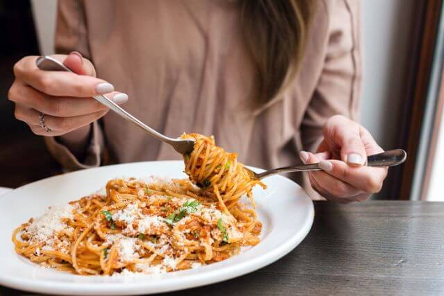 Woman eating spaghetti.