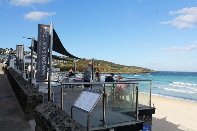 Porthmeor Beach Café in front of Porthmeor Beach in St Ives, Cornwall.