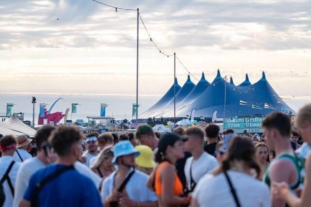 View of the crowds, stage tents and the sea in the distance at Boardmasters, a Cornwall festival in Newquay.